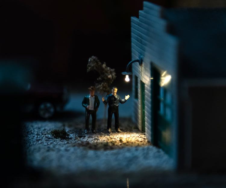Lamp with building and men